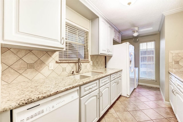 12550 Whittington Dr Unit 816, Houston, TX 77077 - kitchen with white appliances, backsplash, light stone countertops, a textured ceiling, and white cabinets