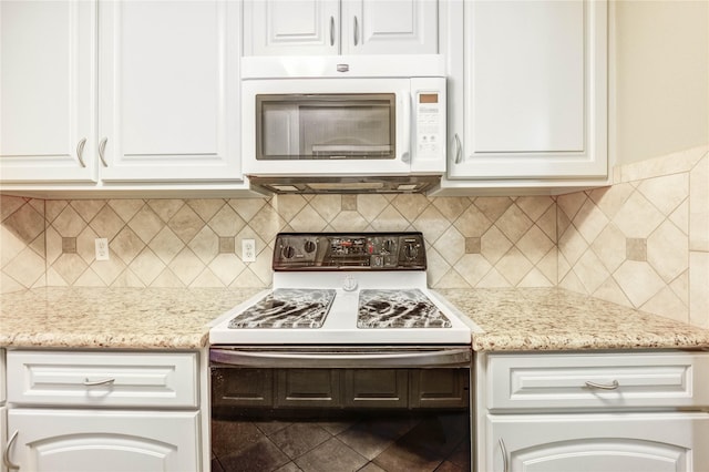 12550 Whittington Dr Unit 816, Houston, TX 77077 - kitchen with white appliances, white cabinets, light stone countertops, and decorative backsplash