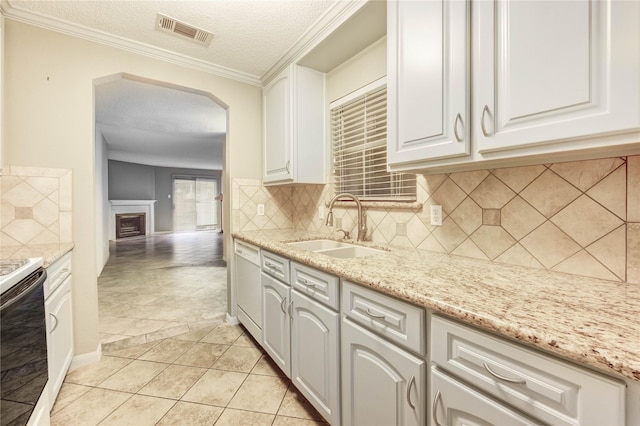 12550 Whittington Dr Unit 816, Houston, TX 77077 - kitchen featuring arched walkways, stove, a textured ceiling, white cabinets, and backsplash