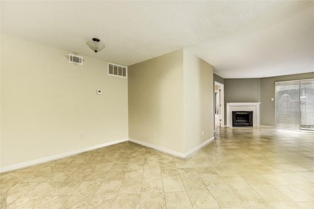 12550 Whittington Dr Unit 816, Houston, TX 77077 - unfurnished living room featuring a fireplace, light tile patterned floors, and a textured ceiling