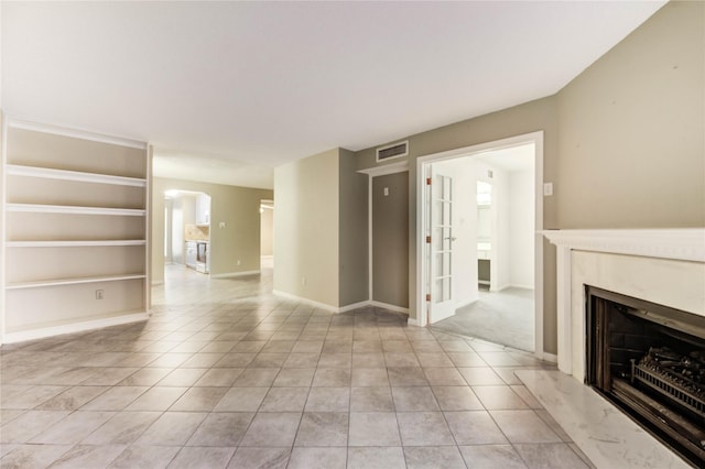 12550 Whittington Dr Unit 816, Houston, TX 77077 - unfurnished living room with a fireplace, arched walkways, and light tile patterned floors