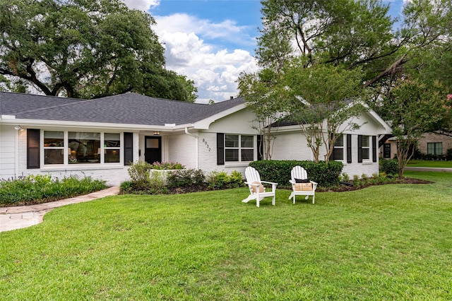 8932 Padfield St, Houston, TX 77055 - view of front of home featuring a front yard, brick siding, and a shingled roof