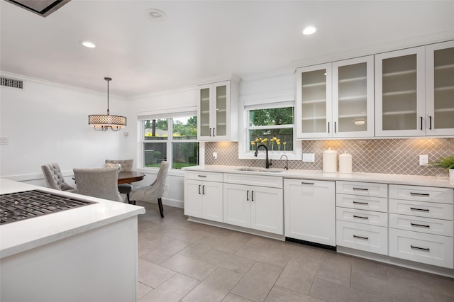8932 Padfield St, Houston, TX 77055 - kitchen featuring dishwasher, backsplash, light countertops, white cabinets, and hanging light fixtures