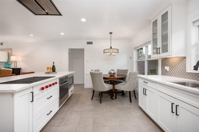 8932 Padfield St, Houston, TX 77055 - kitchen with appliances with stainless steel finishes, backsplash, light countertops, glass insert cabinets, and white cabinetry