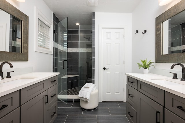 8932 Padfield St, Houston, TX 77055 - bathroom featuring a stall shower, two vanities, and tile patterned floors
