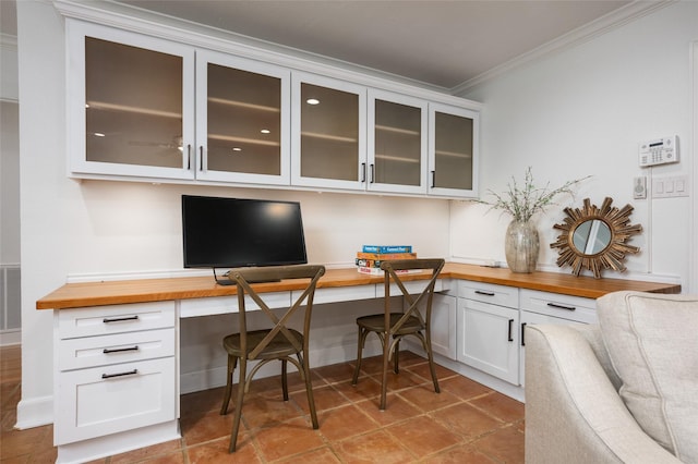 8932 Padfield St, Houston, TX 77055 - home office featuring built in study area, ornamental molding, and tile patterned flooring