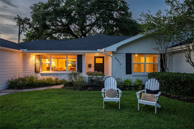 8932 Padfield St, Houston, TX 77055 - view of front of house with a front yard, brick siding, and roof with shingles