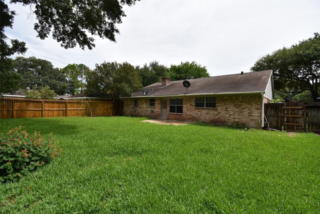 12006 Scottsdale Dr, Meadows Place, TX 77477 - back of property with brick siding, a fenced backyard, and a patio area