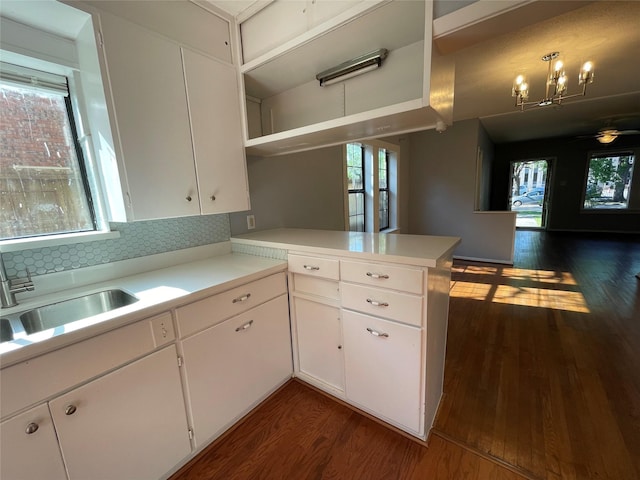 1805 Sul Ross St, Houston, TX 77098 - kitchen with dark wood finished floors, light countertops, open shelves, a peninsula, and tasteful backsplash