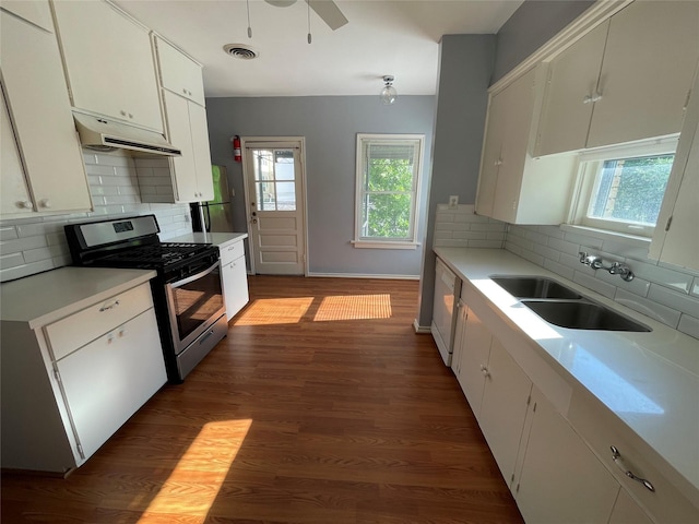 1805 Sul Ross St, Houston, TX 77098 - kitchen with stainless steel range with gas stovetop, under cabinet range hood, light countertops, and healthy amount of natural light