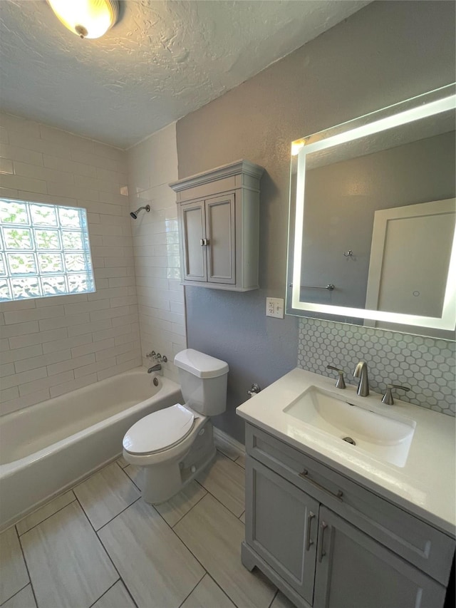 1805 Sul Ross St, Houston, TX 77098 - full bathroom featuring vanity, bathing tub / shower combination, a textured ceiling, and decorative backsplash