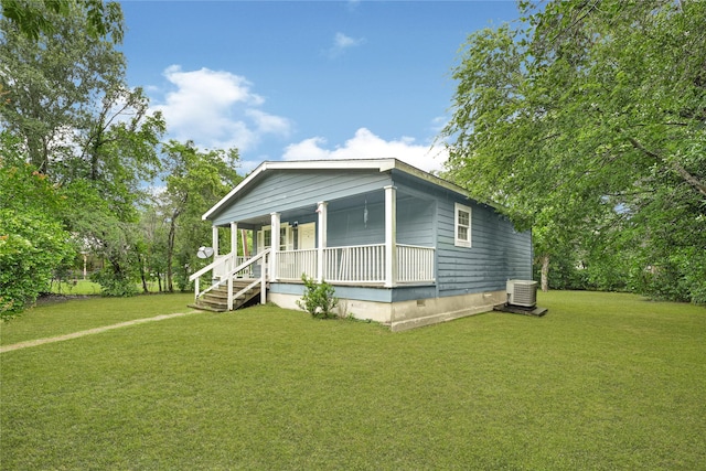 16839 Yates St, Splendora, TX 77372 - view of front of house featuring a porch and a front lawn