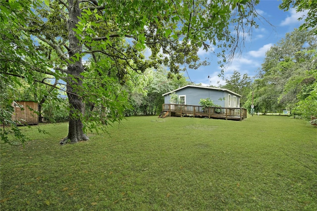 16839 Yates St, Splendora, TX 77372 - view of green lawn with a wooden deck