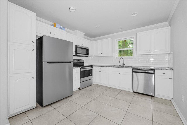 16839 Yates St, Splendora, TX 77372 - kitchen featuring appliances with stainless steel finishes, crown molding, tasteful backsplash, white cabinets, and light stone counters