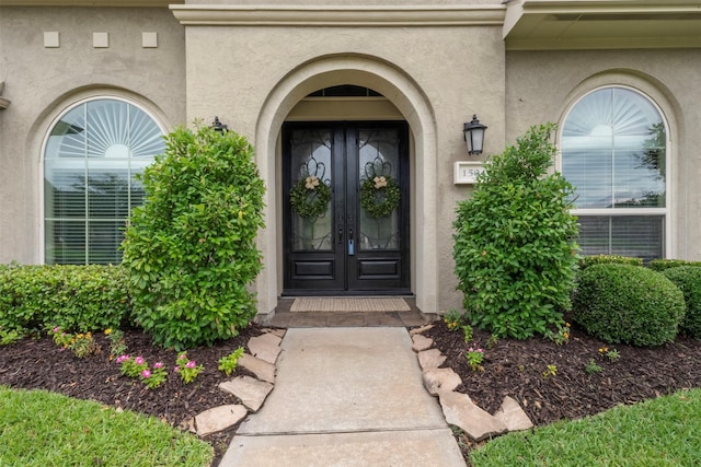 1504 Moreland Park Ct, Friendswood, TX 77546 - view of exterior entry featuring french doors and stucco siding