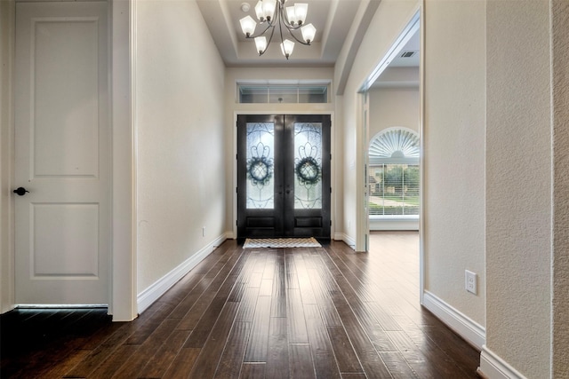 1504 Moreland Park Ct, Friendswood, TX 77546 - foyer entrance with a chandelier, dark wood-style flooring, a textured wall, and french doors