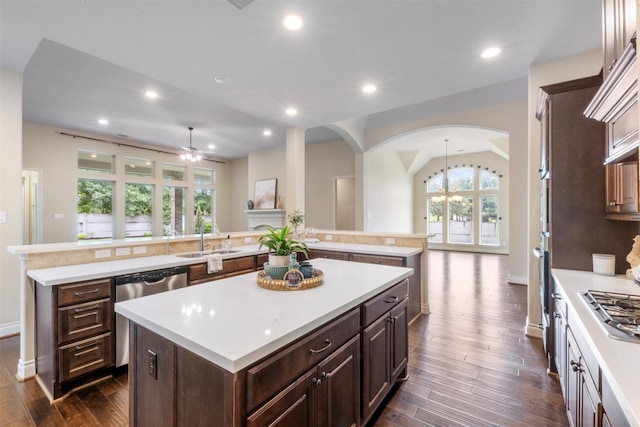 1504 Moreland Park Ct, Friendswood, TX 77546 - kitchen featuring a kitchen island, appliances with stainless steel finishes, arched walkways, ceiling fan, and light countertops
