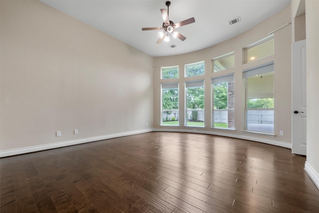 1504 Moreland Park Ct, Friendswood, TX 77546 - empty room featuring healthy amount of natural light, a ceiling fan, and dark wood-style flooring