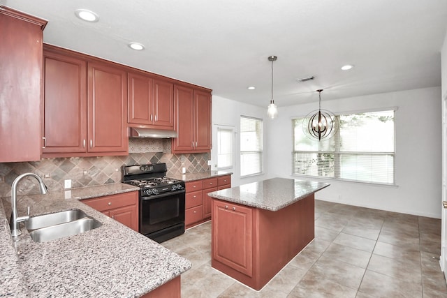 2508 Sun Glen Dr, Pearland, TX 77584 - kitchen featuring black range with gas stovetop, under cabinet range hood, tasteful backsplash, a kitchen island, and light stone counters