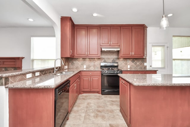 2508 Sun Glen Dr, Pearland, TX 77584 - kitchen with black appliances, under cabinet range hood, backsplash, light stone counters, and pendant lighting