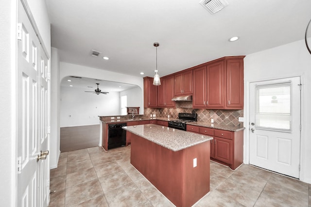 2508 Sun Glen Dr, Pearland, TX 77584 - kitchen with black appliances, a ceiling fan, decorative backsplash, a kitchen island, and light stone counters