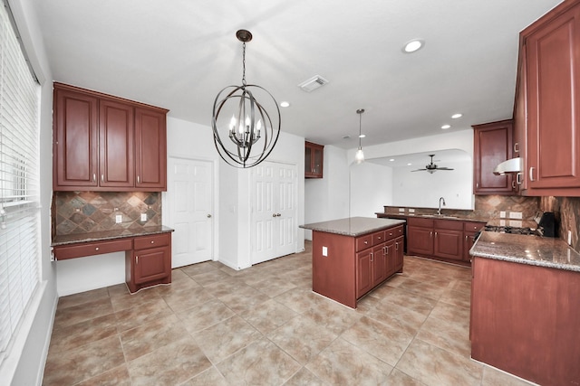 2508 Sun Glen Dr, Pearland, TX 77584 - kitchen with backsplash, a chandelier, light tile patterned floors, under cabinet range hood, and recessed lighting