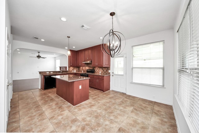 2508 Sun Glen Dr, Pearland, TX 77584 - kitchen featuring black appliances, ceiling fan, under cabinet range hood, a center island, and backsplash