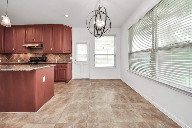 2508 Sun Glen Dr, Pearland, TX 77584 - kitchen featuring under cabinet range hood, range, backsplash, hanging light fixtures, and a chandelier