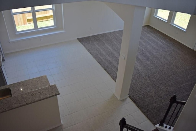 7615 Adobe Canyon Ln, Richmond, TX 77469 - unfurnished living room with light tile patterned floors and light colored carpet