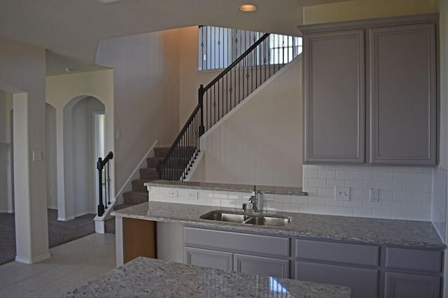 7615 Adobe Canyon Ln, Richmond, TX 77469 - kitchen with gray cabinets, stone counters, and decorative backsplash