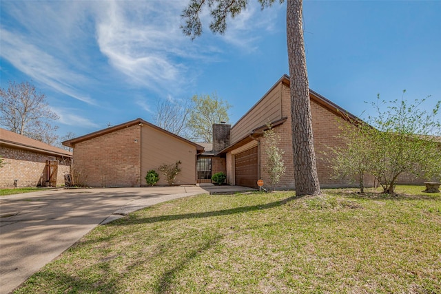 327 Edgeton Ct, Houston, TX 77015 - view of front facade with a chimney, driveway, brick siding, a garage, and a front yard