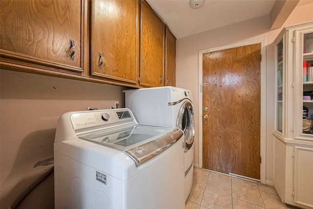 327 Edgeton Ct, Houston, TX 77015 - laundry room with cabinet space, separate washer and dryer, and light tile patterned floors