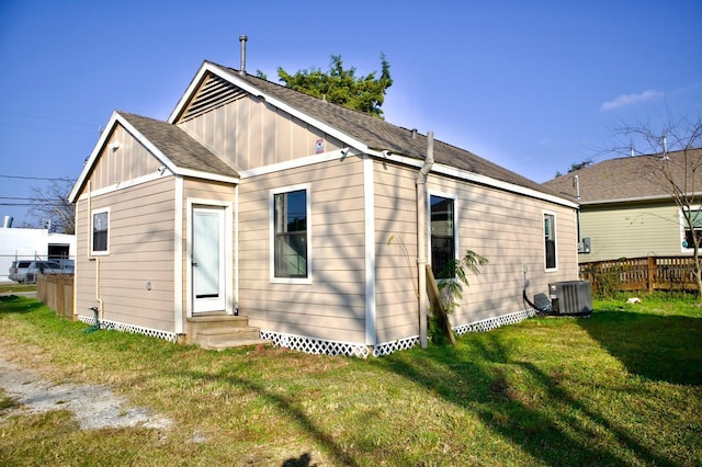 428 Van Molan St, Houston, TX 77022 - rear view of house featuring board and batten siding, entry steps, and roof with shingles