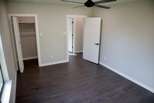 428 Van Molan St, Houston, TX 77022 - unfurnished bedroom with dark wood-type flooring, a closet, ceiling fan, and a walk in closet