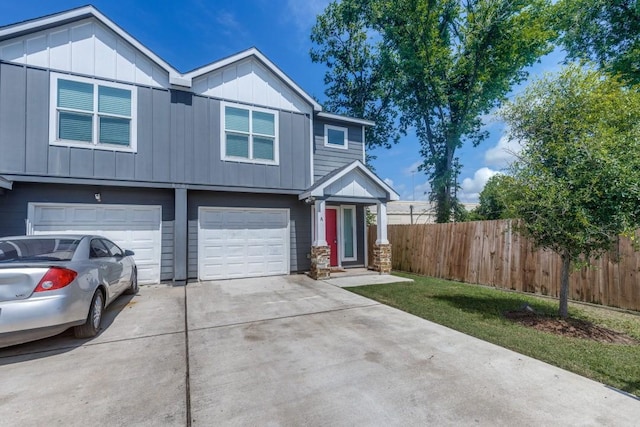 8206 Bassett St, Houston, TX 77051 - view of front of home with driveway, board and batten siding, and a garage