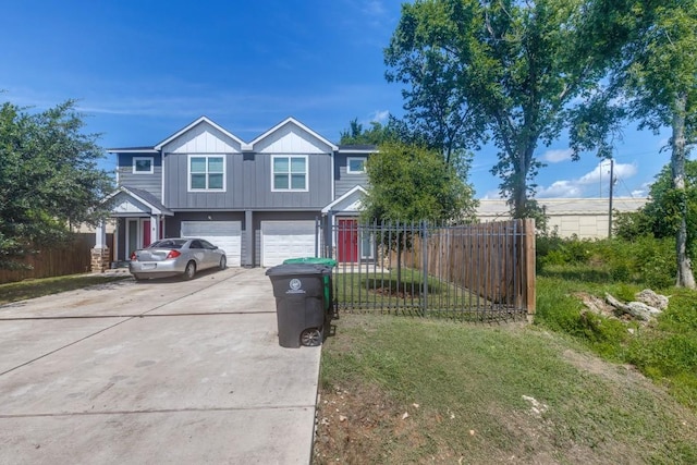 8206 Bassett St, Houston, TX 77051 - view of front of home with driveway, an attached garage, and board and batten siding
