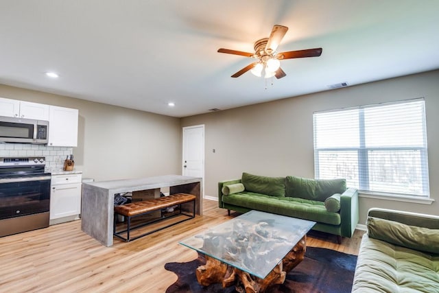 8206 Bassett St, Houston, TX 77051 - living room with ceiling fan, light wood-style floors, and recessed lighting