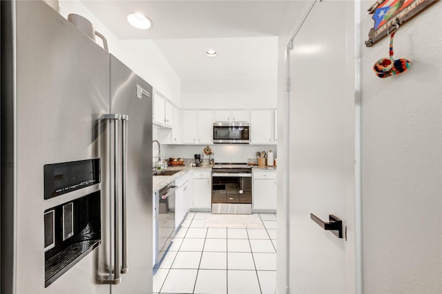1572 Prairie Grove Dr, Houston, TX 77077 - kitchen with appliances with stainless steel finishes, light tile patterned floors, white cabinets, and recessed lighting