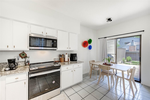 1572 Prairie Grove Dr, Houston, TX 77077 - kitchen featuring stainless steel appliances, white cabinetry, and light tile patterned flooring