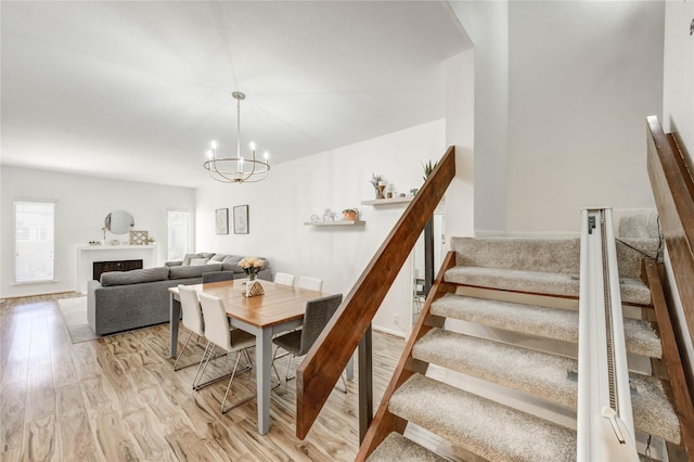 1572 Prairie Grove Dr, Houston, TX 77077 - dining room with stairs, light wood-type flooring, and a chandelier