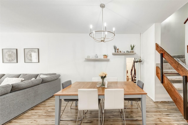 1572 Prairie Grove Dr, Houston, TX 77077 - dining room with stairs, light wood finished floors, and a chandelier