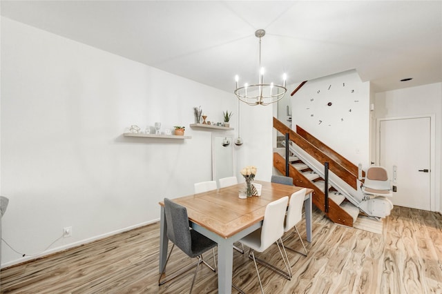 1572 Prairie Grove Dr, Houston, TX 77077 - dining space with light wood-style floors, a chandelier, and stairs