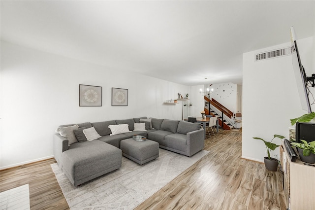 1572 Prairie Grove Dr, Houston, TX 77077 - living room featuring a chandelier, light wood-style floors, and stairs