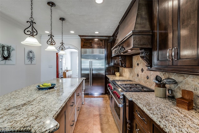 12042 Bolero Point Ln, Houston, TX 77041 - kitchen featuring high end appliances, ornamental molding, light stone countertops, tasteful backsplash, and a kitchen island
