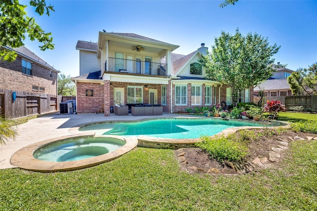 12042 Bolero Point Ln, Houston, TX 77041 - back of property featuring a balcony, ceiling fan, a fenced backyard, and brick siding