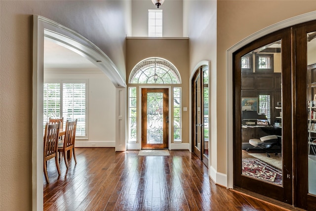 12042 Bolero Point Ln, Houston, TX 77041 - foyer entrance with dark wood-style floors, a towering ceiling, and arched walkways