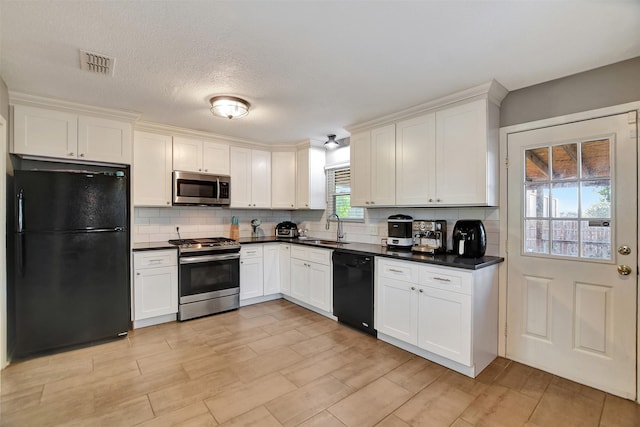 29515 Quinn Rd, Tomball, TX 77375 - kitchen featuring black appliances, dark countertops, backsplash, and white cabinetry
