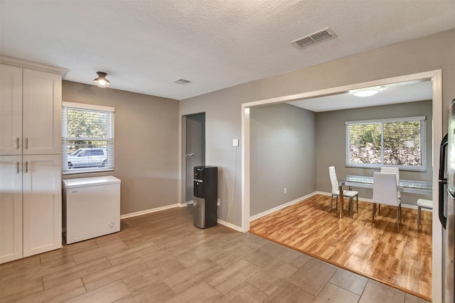 29515 Quinn Rd, Tomball, TX 77375 - dining space with light wood-style flooring, healthy amount of natural light, and a textured ceiling