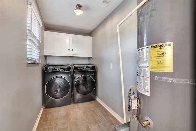 29515 Quinn Rd, Tomball, TX 77375 - washroom featuring water heater, cabinet space, and washing machine and clothes dryer