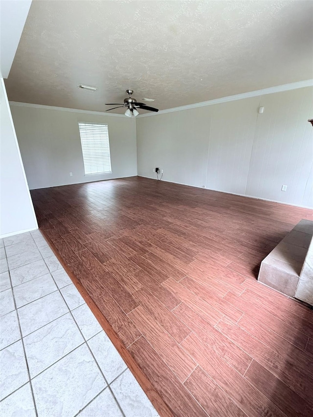 10302 Sageplum Dr, Houston, TX 77089 - unfurnished living room featuring a ceiling fan, light wood-style floors, crown molding, and a textured ceiling